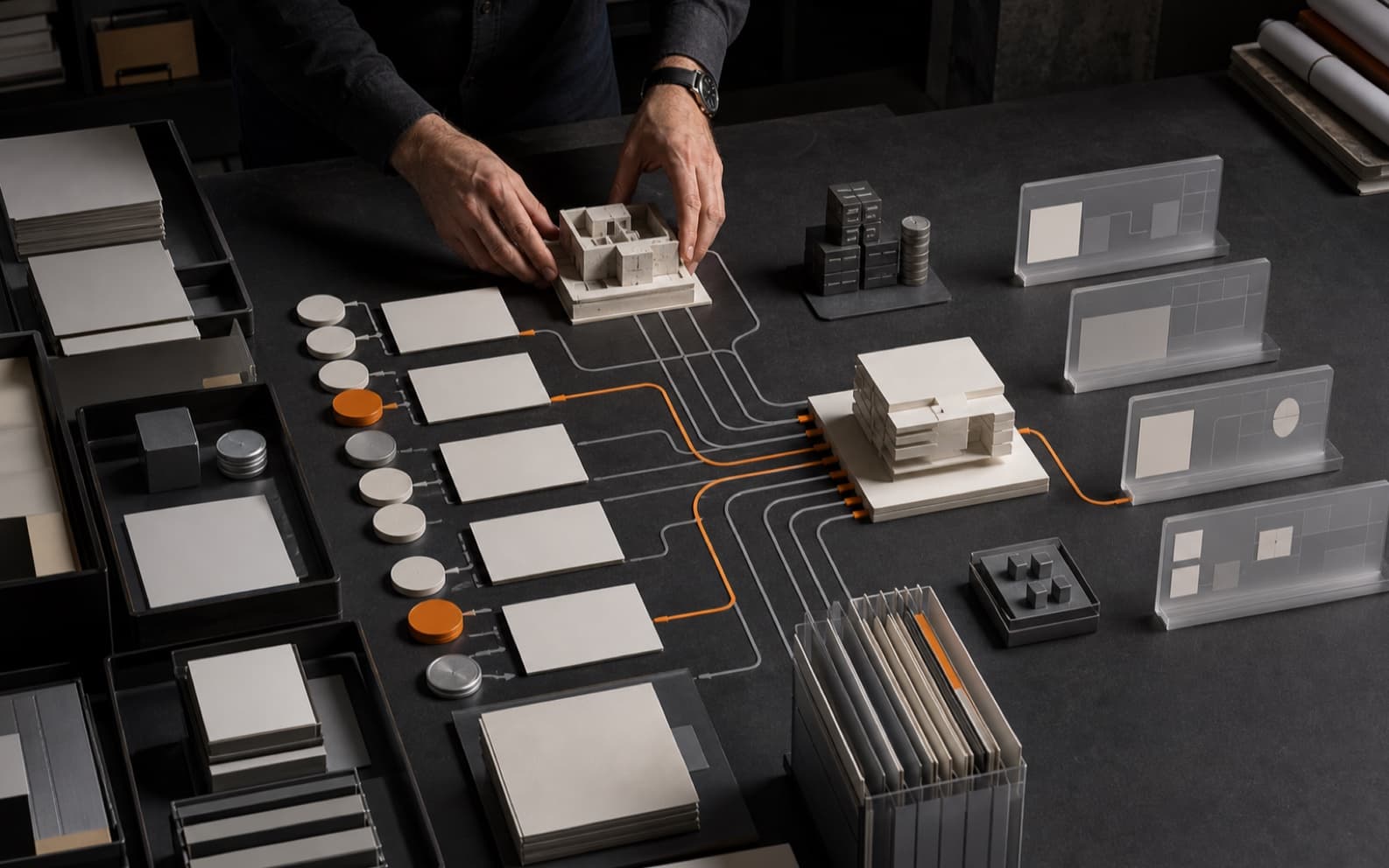 AEC information manager organizing a building model, blank issue cards, document trays, cost tokens, and abstract dashboard panels as fragmented graphite paths converge through orange lines into one ordered information structure.
